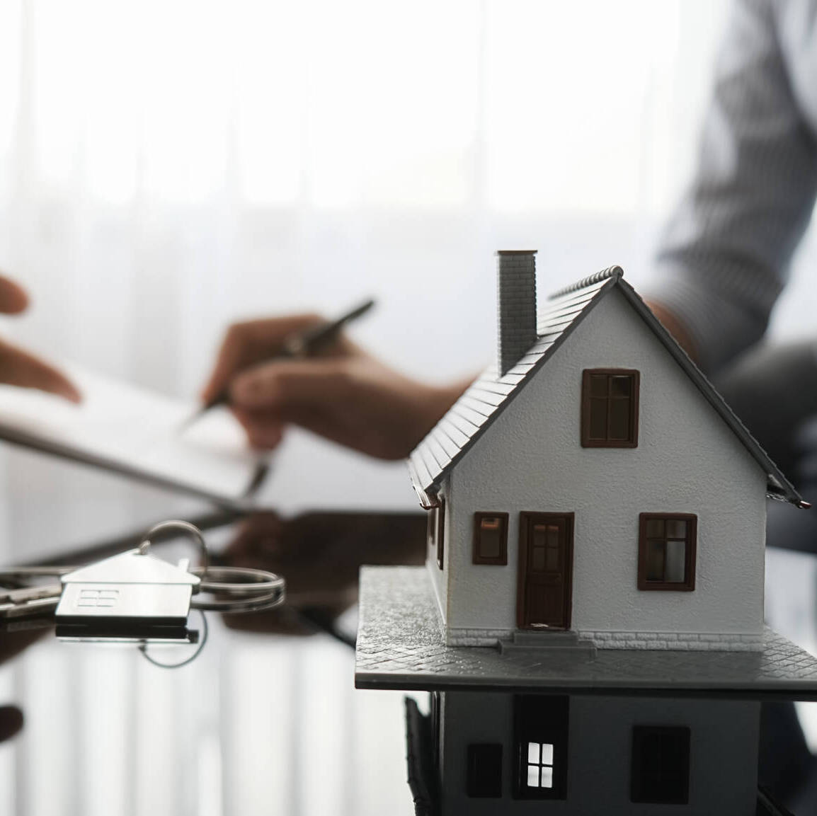 Real Estate Agent And Customer Signing Contract To Buy House, In
